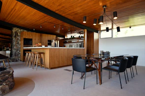 a room with a table and chairs and a bar
