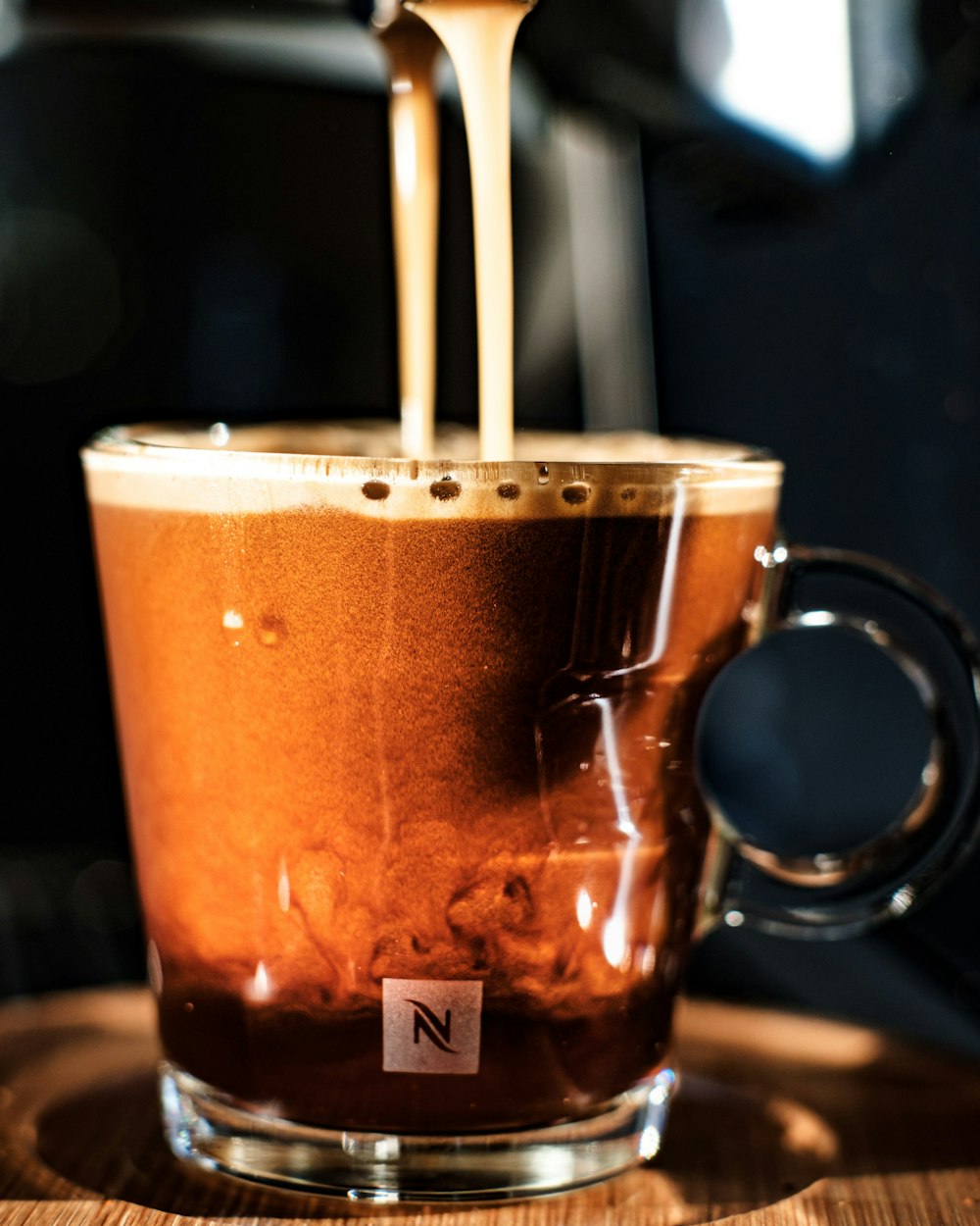 a cup of coffee being poured into it