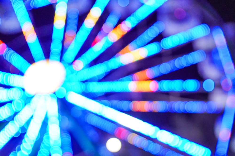 a close up of a ferris wheel at night