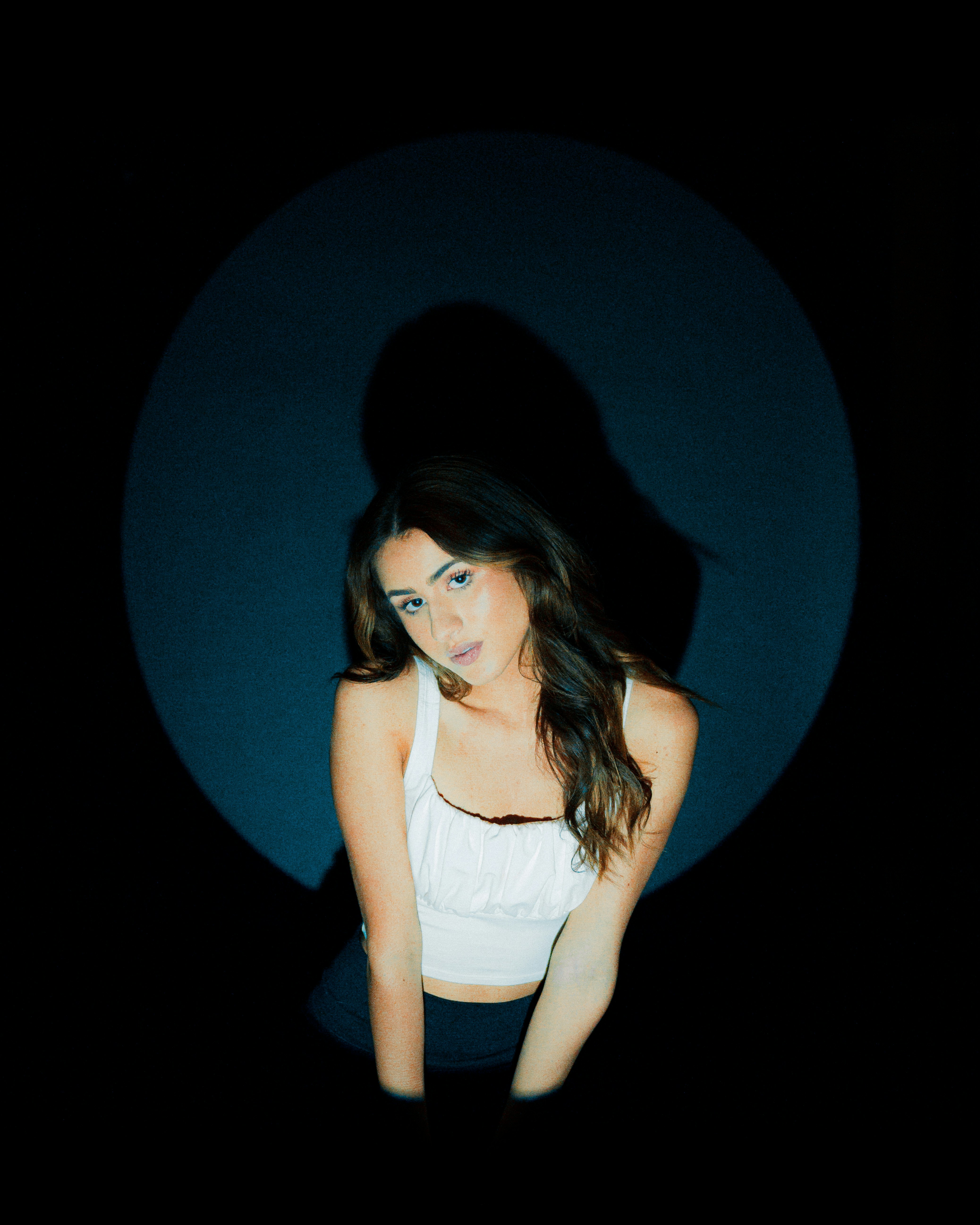 a woman in a white top is posing for a picture