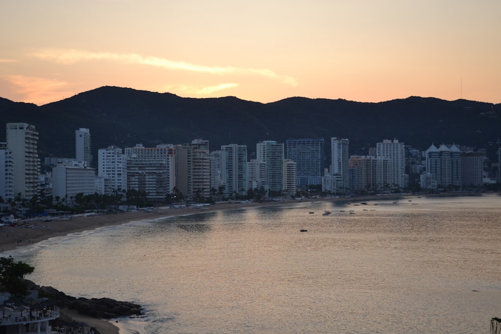 a view of a beach with a city in the background