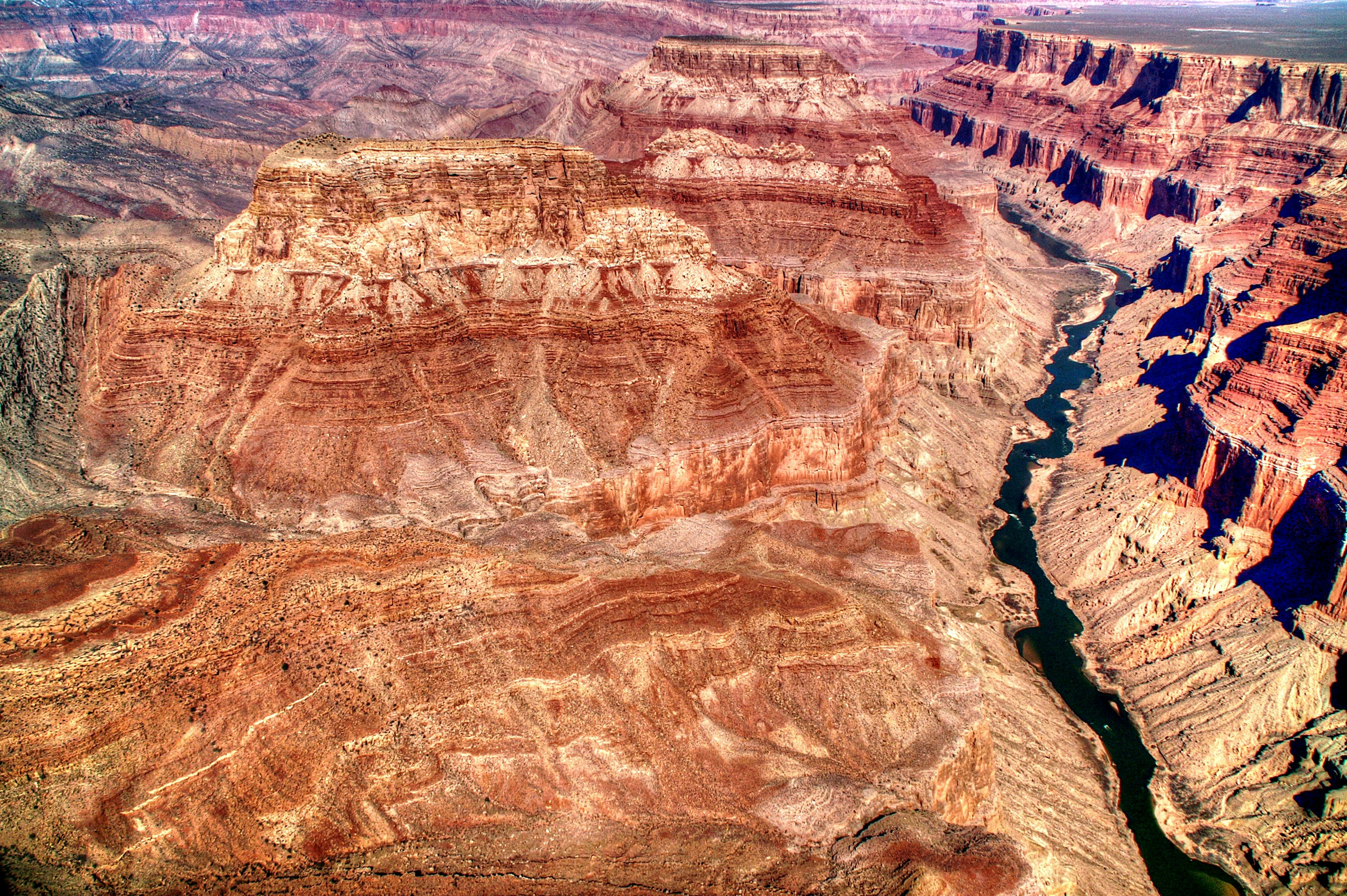 an aerial view of a canyon with a river running through it, Grand Canyon National Park and Colorado River from the Helicopter - 13</p><p>This is a view of the Grand Canyon and Colorado River from the helicopter.