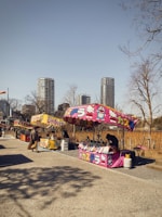 Visitors browsing colorful stalls representing different armed forces branches.