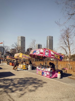 Visitors browsing colorful stalls representing different armed forces branches.
