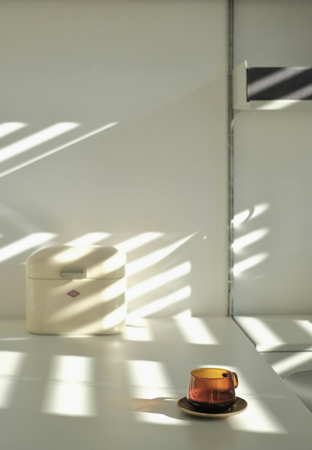 a cup and saucer sitting on a white table