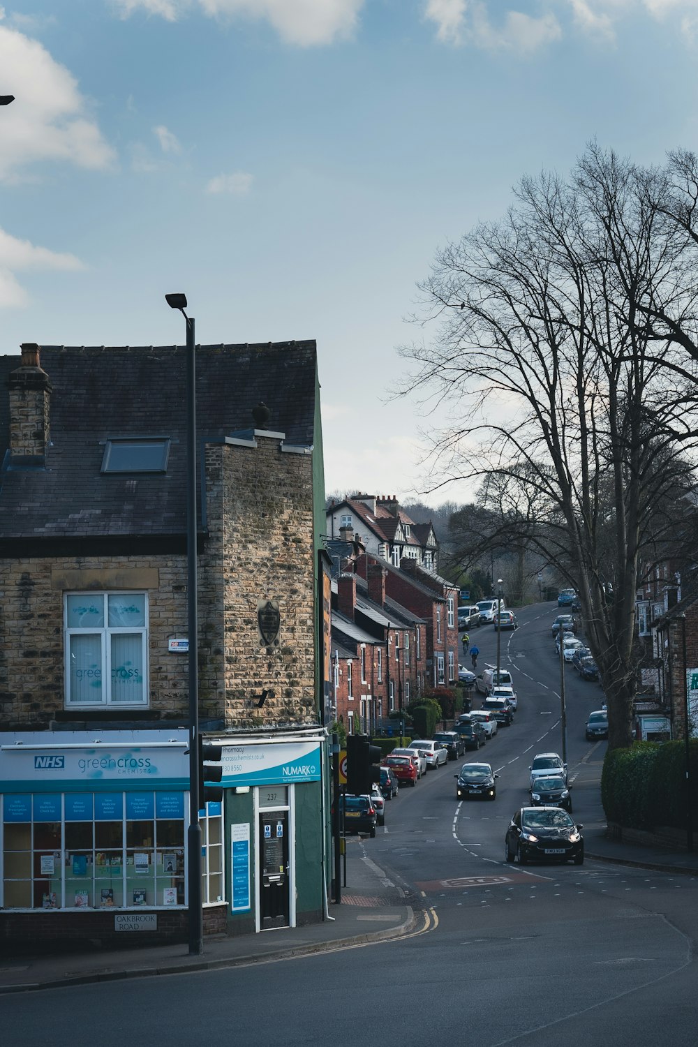 a street with cars parked on the side of a building