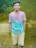 a man standing in a field with a frisbee