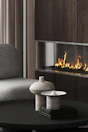 Mood-lit living area with modern art and a sleek fireplace creating a warm ambiance.