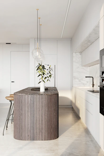 A sleek kitchen island in walnut wood with integrated storage and modern pendant lighting above