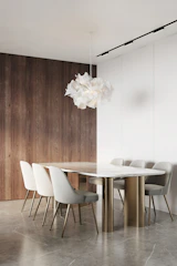 Elegant dining table set with minimalist design and soft golden light highlighting textures.