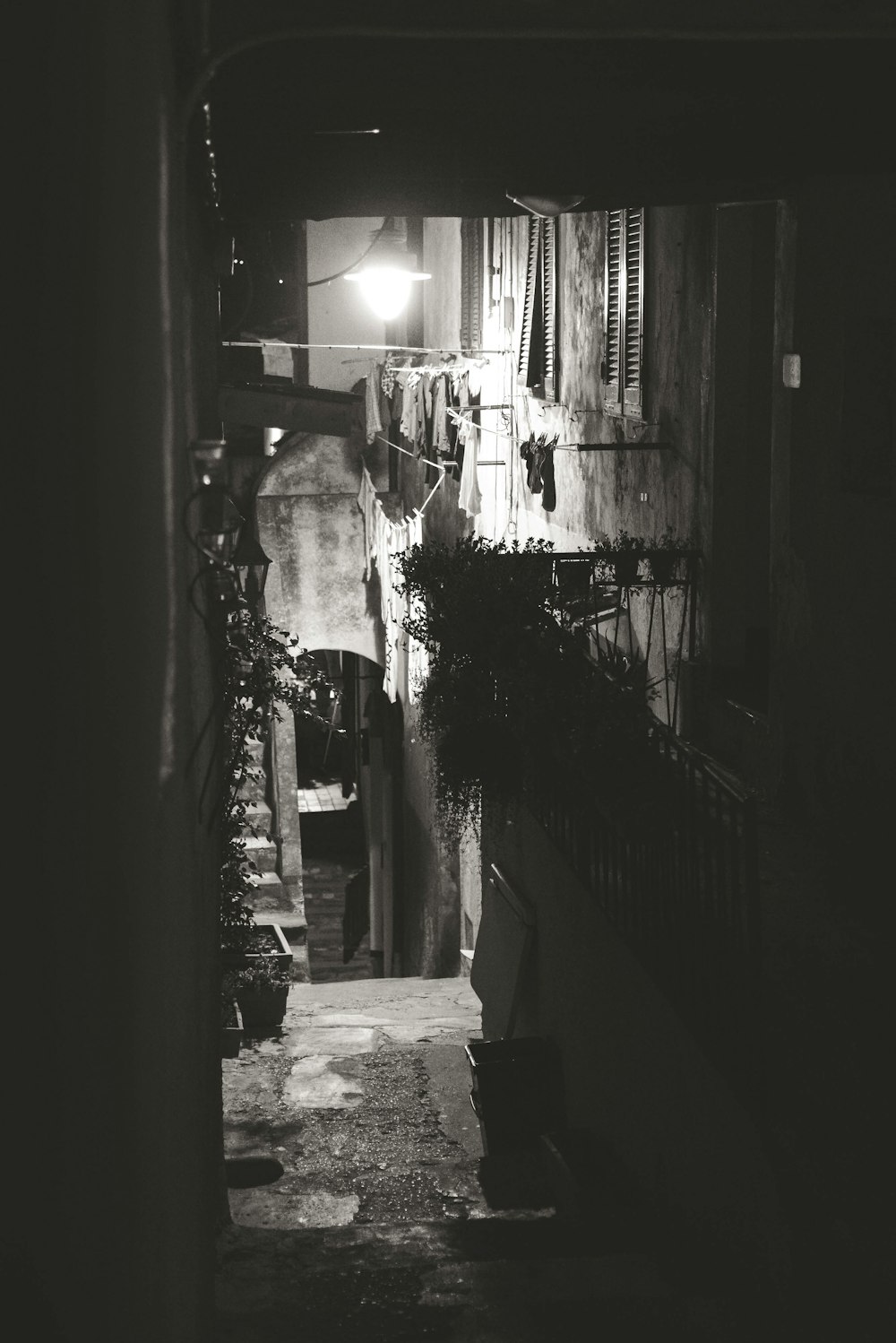 a narrow alley way with a light on