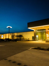 Secure parking area with well-lit spaces near the hotel entrance at dusk.