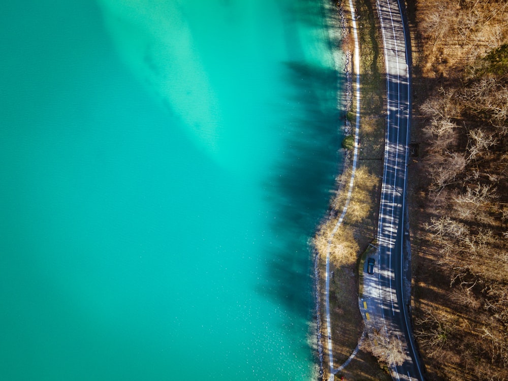 a road next to a body of water