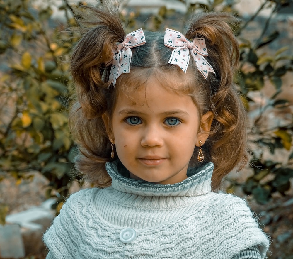 a little girl with a flower crown