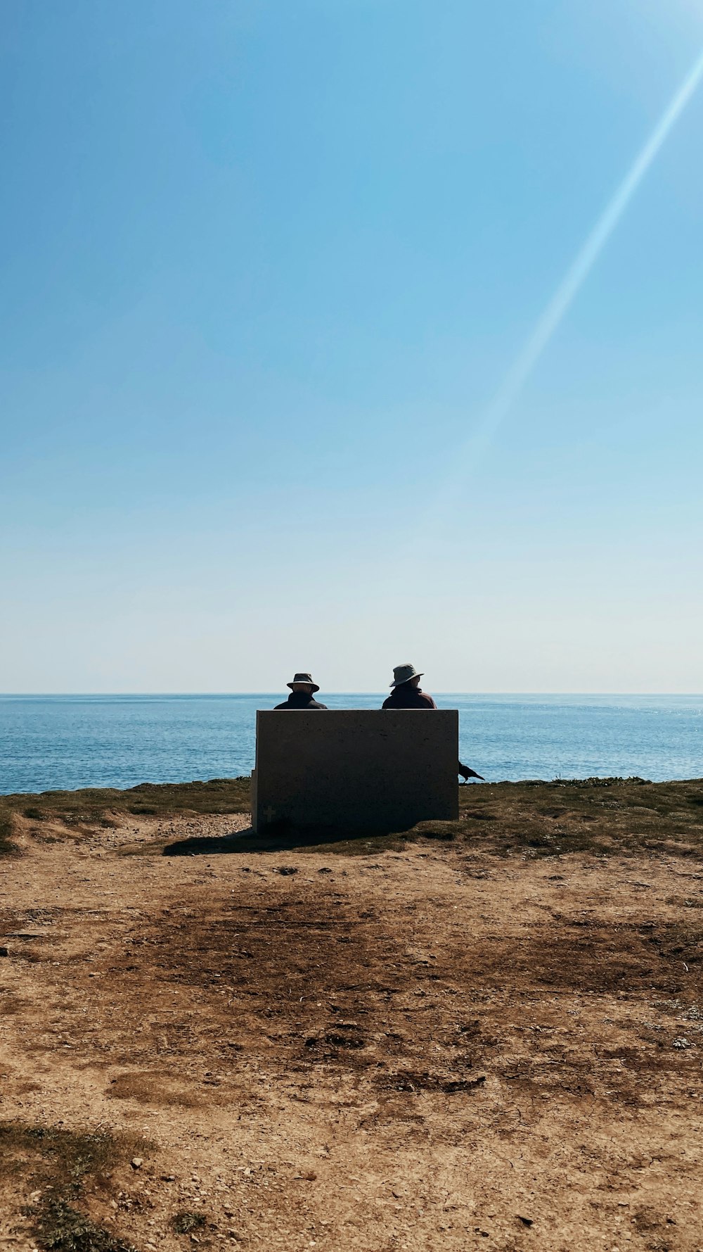 two people sitting on a bench