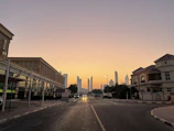 A minimalist photo of an empty urban street at dawn with soft lighting.
