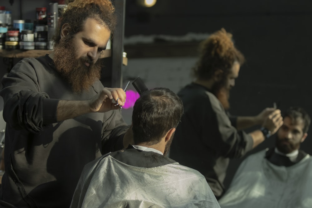 a man cutting another man's hair