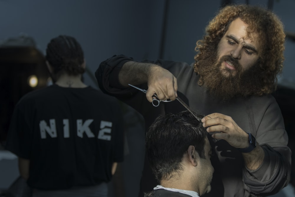 a man cutting another man's hair