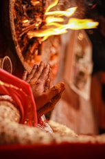 a person's hand with a red glove and a red and yellow background