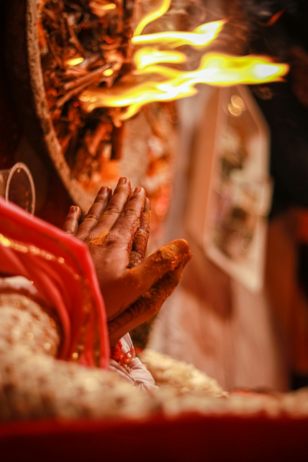 a person's hand with a red glove and a red and yellow background