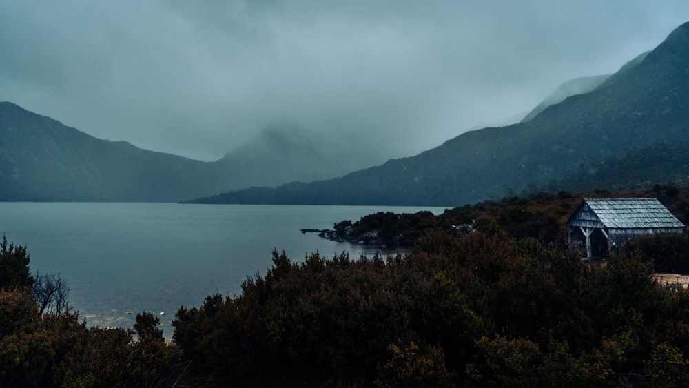 a house on a hill by a lake