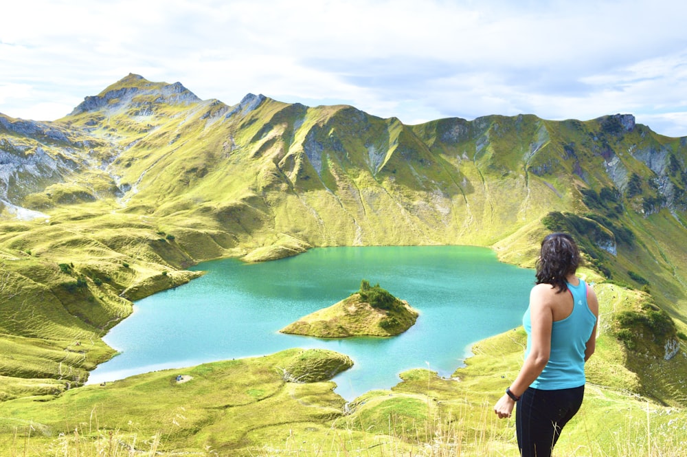 a person standing on a hill overlooking a body of water