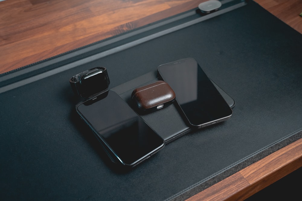 a couple of black rectangular objects on a black surface