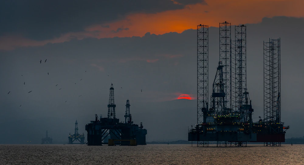 Offshore oil and gas platform at sunset