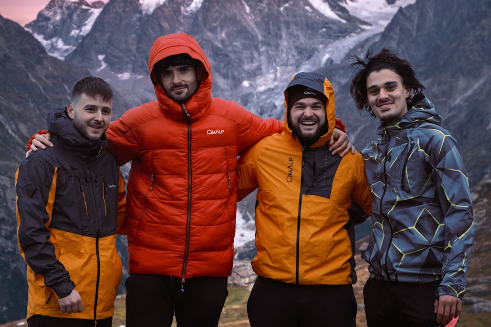 um grupo de homens posando para uma foto em uma montanha