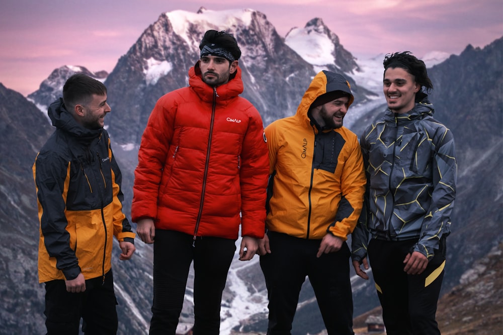 a group of men posing for a picture in front of a mountain