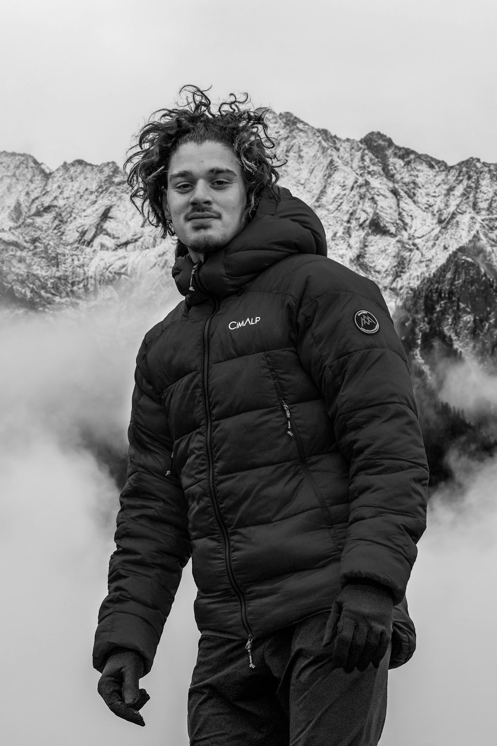 a man standing in front of a mountain