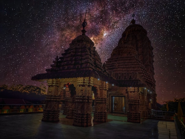 A serene cosmic temple under a starry sky, glowing softly with celestial light.