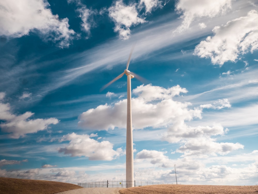 a windmill under a cloudy sky