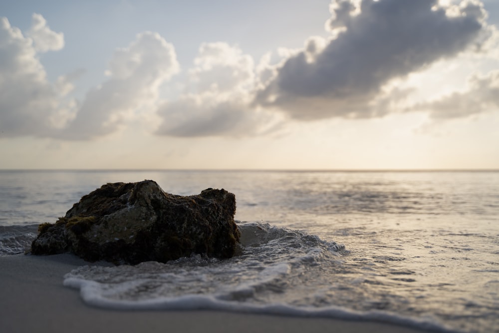 a rocky beach with waves crashing against it