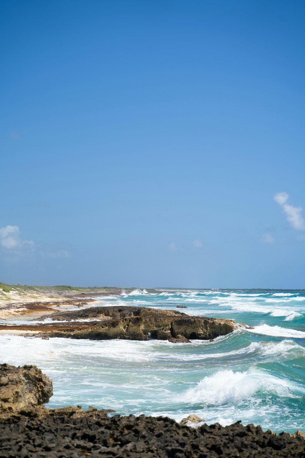 a rocky beach with blue water