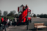 Happy tourists sharing a laugh while boarding a vintage tour bus.