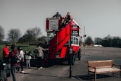 Group of passengers boarding a spacious 72-seater coach at Gatwick South Terminal.