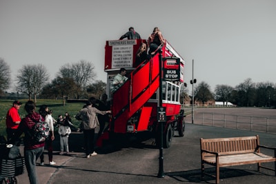 A luxury coach bus parked near a famous European landmark with happy tourists boarding.