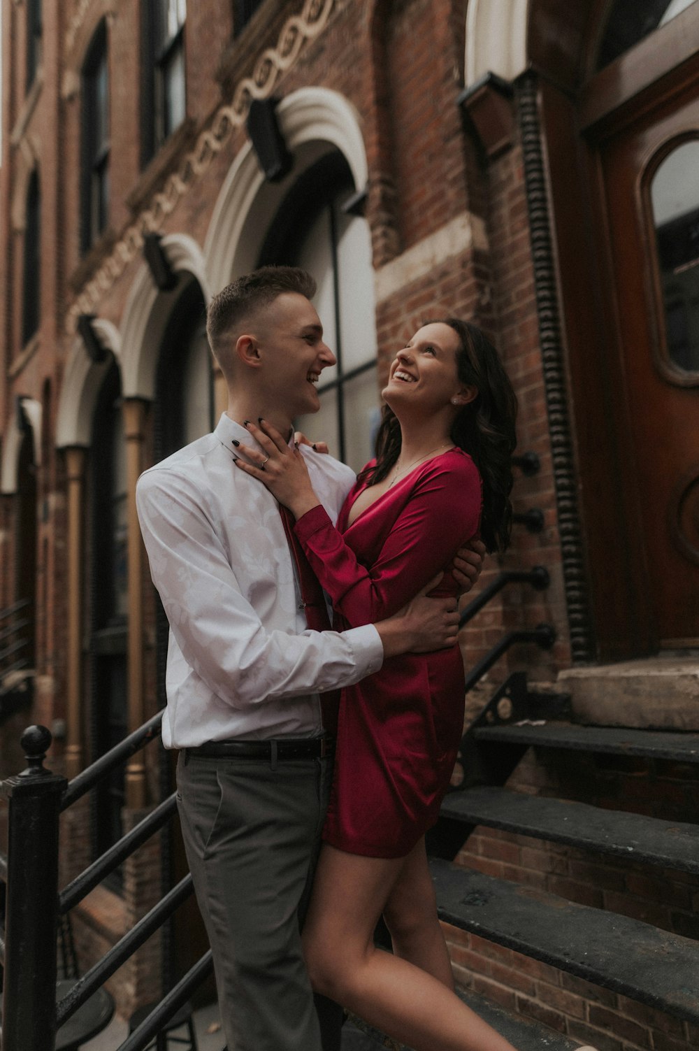 a man and woman kissing on a balcony