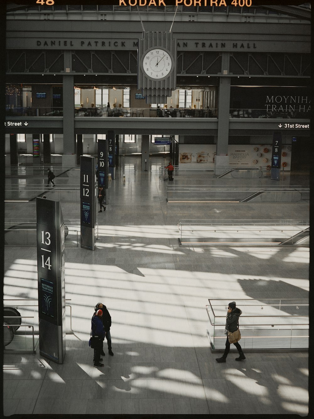 a clock on a pole in a train station