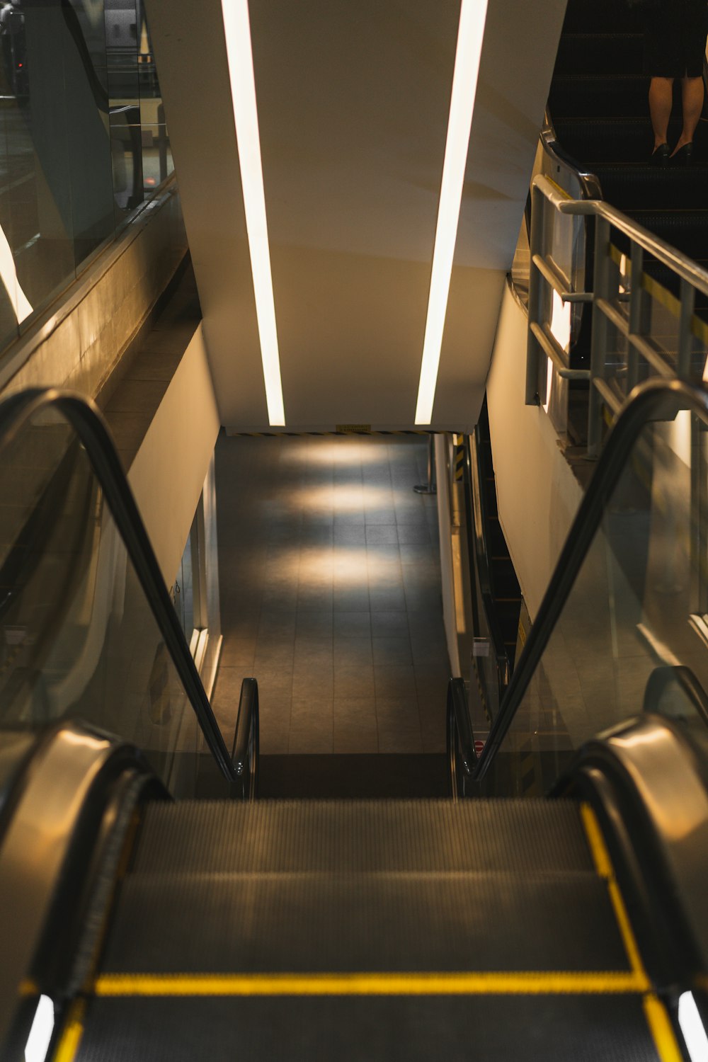 a long escalator with a light on the top