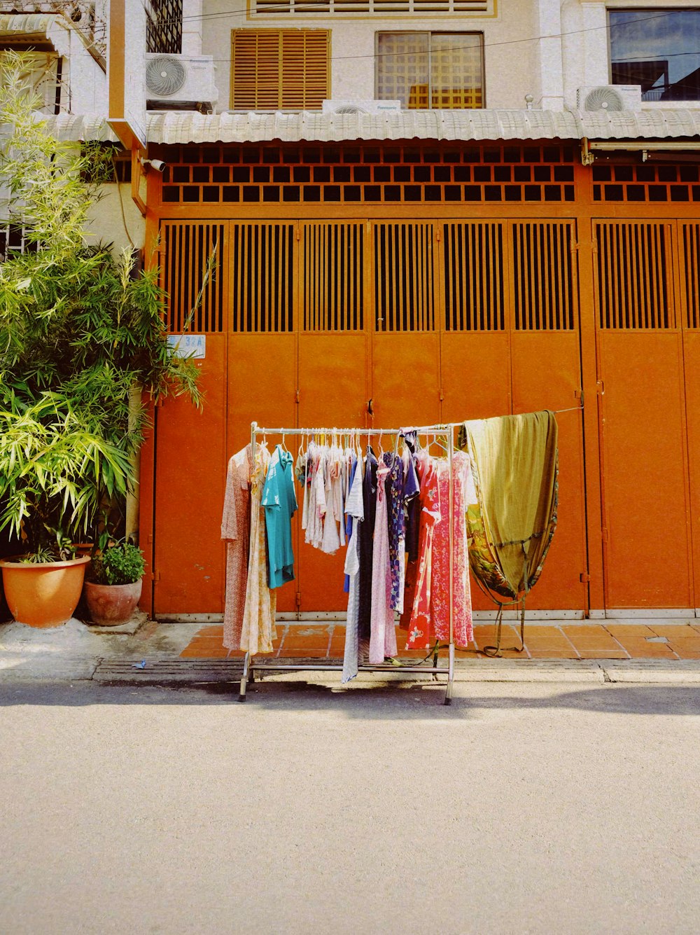 a row of clothes outside of a building