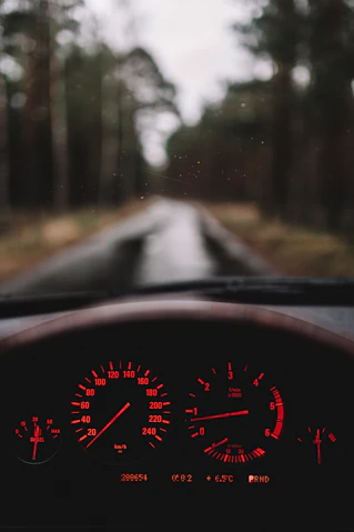 a car dashboard with a red light