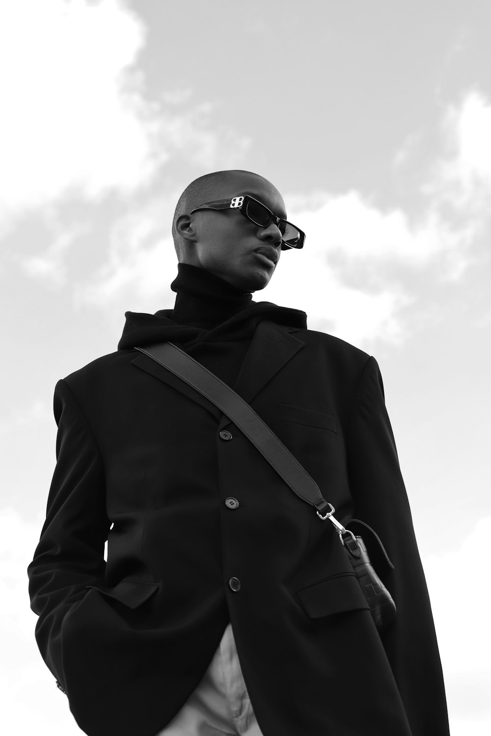 a man wearing a black jacket and sunglasses