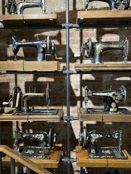 A cozy corner inside the sewing museum with vintage sewing machines and colorful threads neatly arranged.