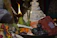 Close-up of a polished brass pooja thali with traditional lamps and incense sticks.