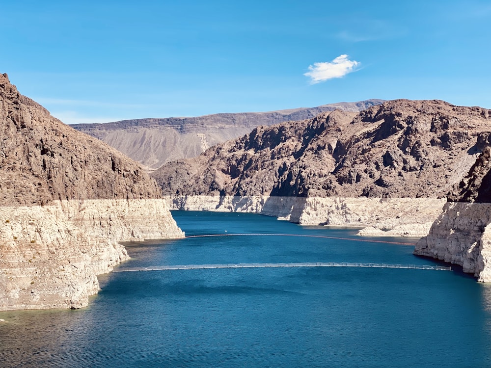 a body of water with rocky cliffs with Lake Mead in the background