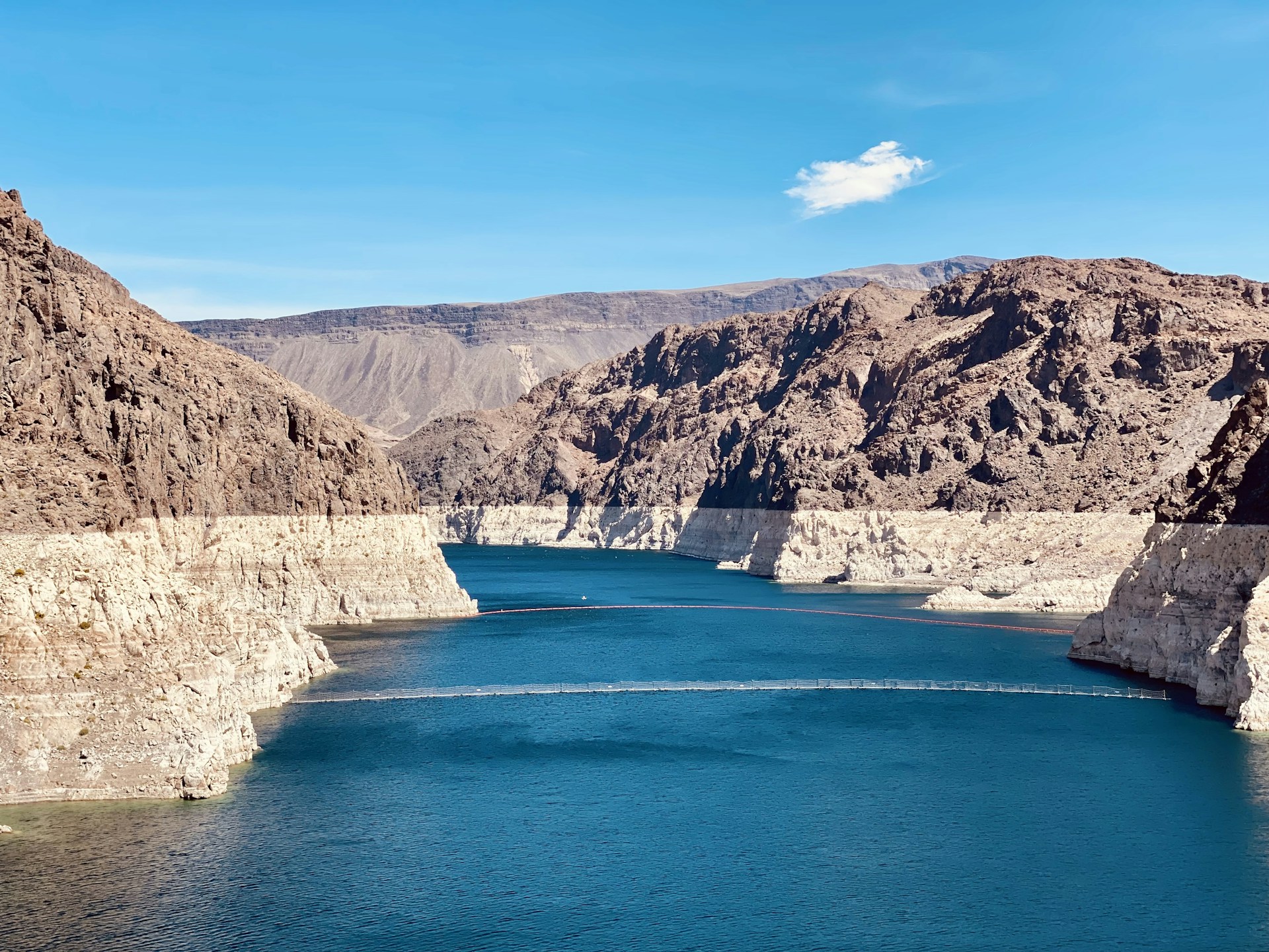 a body of water with rocky cliffs with Lake Mead in the background