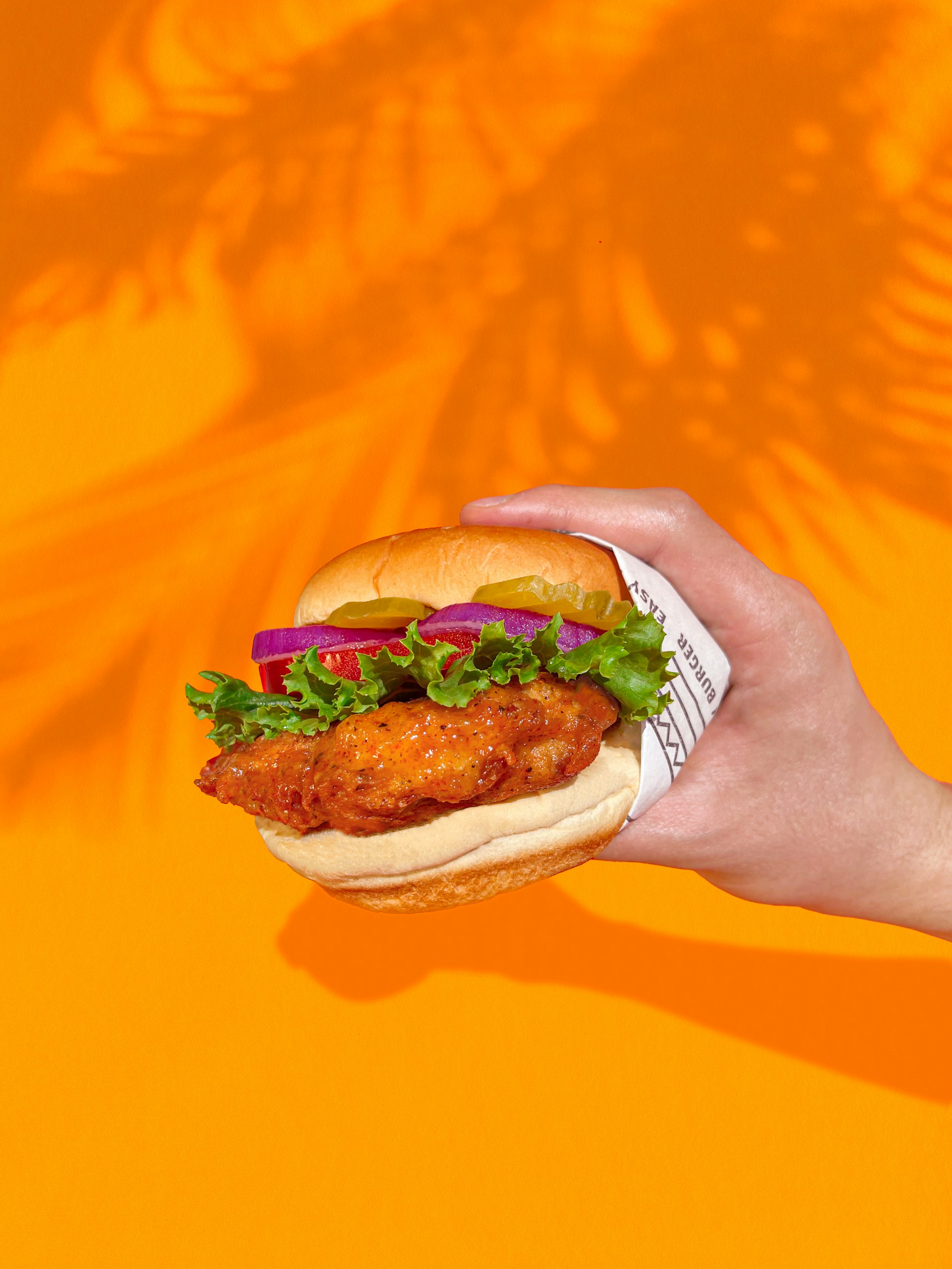 a hand holding a sandwich