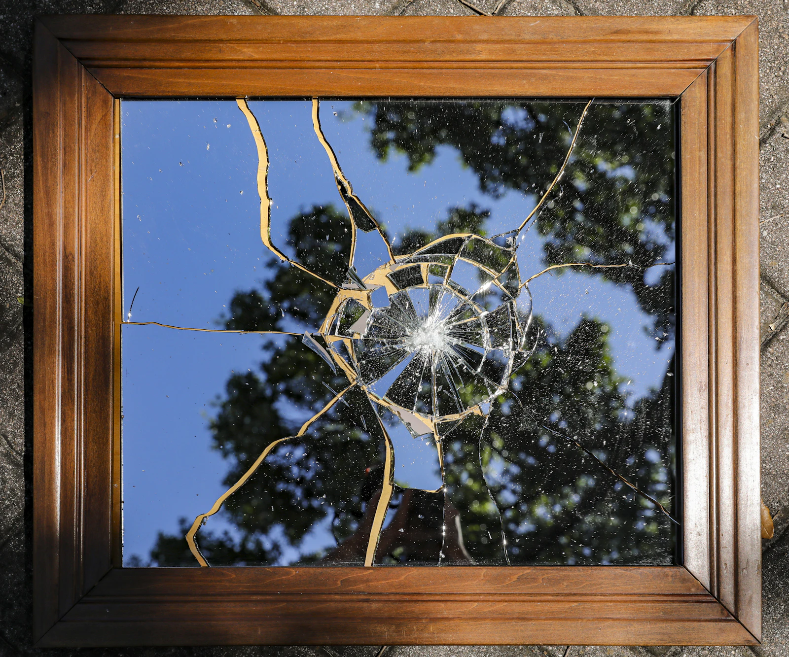 Shattered mirror pieces reflecting fragmented light, creating multiple perspectives and distorted reflections